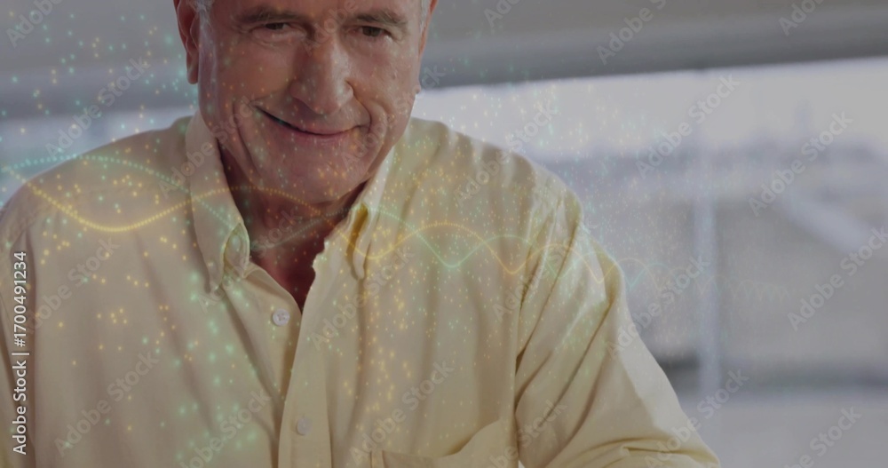 Poster smiling senior man in button-up shirt examining digital waveform overlay at large office window