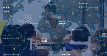 Collaborating professionals analyzing projections on map overlay in modern boardroom, with laptops
