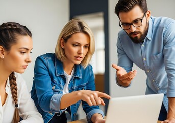 Three colleagues collaborating on a project using a laptop