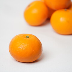Isolated white Wokam Orange or often known as Mandarin Orange which is still fresh with bright orange skin.