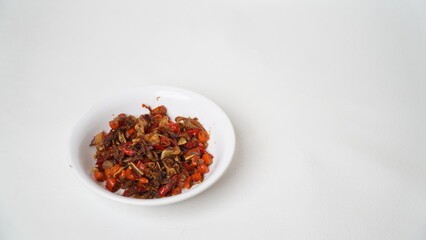 Sambal Embe, a typical Balinese chili sauce, Indonesia, served on a white plate with a white base (isolated white).
