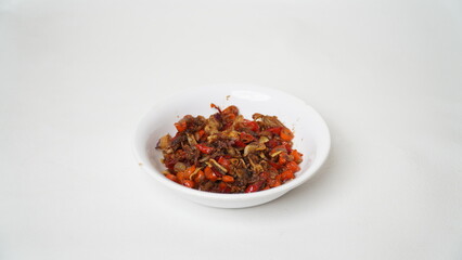 Sambal Embe, a typical Balinese chili sauce, Indonesia, served on a white plate with a white base (isolated white).