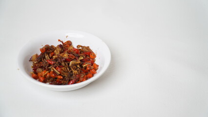 Sambal Embe, a typical Balinese chili sauce, Indonesia, served on a white plate with a white base (isolated white).