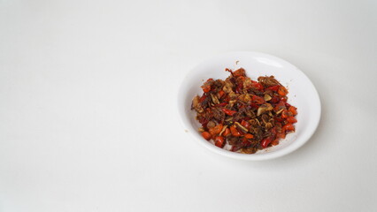 Sambal Embe, a typical Balinese chili sauce, Indonesia, served on a white plate with a white base (isolated white).