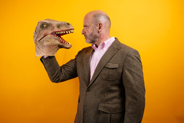 Man in suit holding dinosaur head