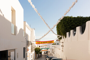 Conil de la Frontera, Cadiz, Andalusia, Spain. 6 September 2025. Whitewashed building with festival decorations © Ulysses