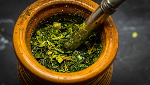 Macro close-up of vibrant yerba mate leaves in a traditional wooden gourd with a bombilla - Powered by Adobe