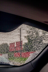 View from the inside of a working car,Car traffic jam,illuminated road during heavy rain and...