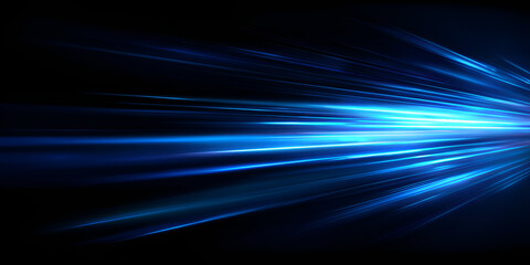 Fast motion blur of glowing blue streaks on dark background, digital light concept