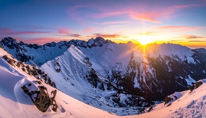 Panoramic view of snow-covered mountains at sunset, with golden light casting dramatic shadows across rugged peaks and valleys, evoking serenity, elevation, and the sublime beauty of winter.