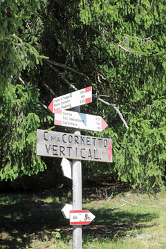 indicator sign with arrows and the names of locations and mountains showing the right path to follow in Italy on the European Alps