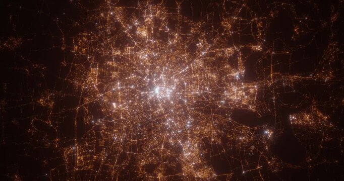 Leipzig (Germany) aerial view at night. Top view on modern city with street lights. Camera is zooming out, rotating counterclockwise. Vertical video. The north is on the left side