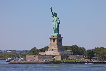 Fototapeta premium famous Statue of Liberty seen from the sea on a sunny daytime on the island