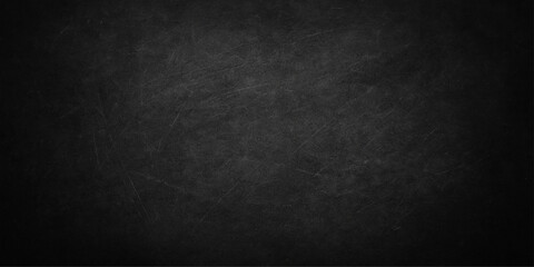 Old, dirty black paper texture with a blank, dark grunge wall background and a vintage black and white chalkboard pattern