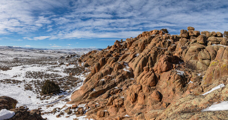 Fototapeta premium This winter panorama of Hartman Rocks in Gunnison, Colorado, features a rock formation on the Behind the Rocks trail under a partly cloudy blue sky.
