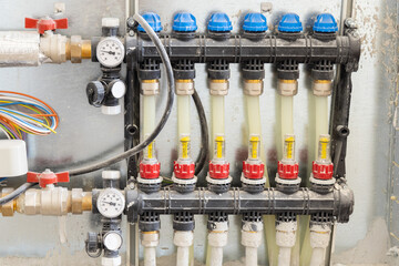 Pipes and valves for hot and cold water in heating and water supply system in boiler room closeup