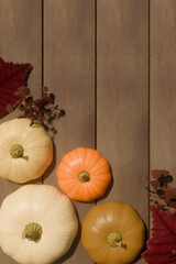 Autumn pumpkins with fall leaves on wooden background for thanksgiving decoration. 3d rendering