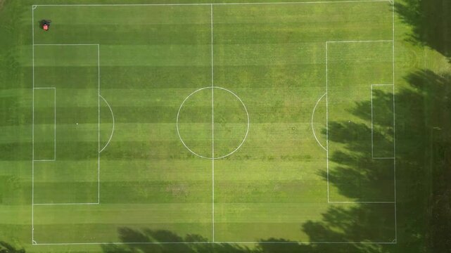 4K hyperlapse of a groundsman mowing the grass on a football pitch in Glasgow, Scotland