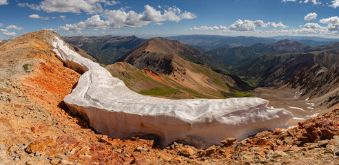 A large cornice remains on Colorado 13er Every Mountain in this summer panorama of the beautiful San Juan Range near Lake City, CO. © Nick Monitello