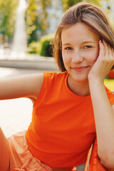 Yoga inspiration: joyful woman relaxing in summer park