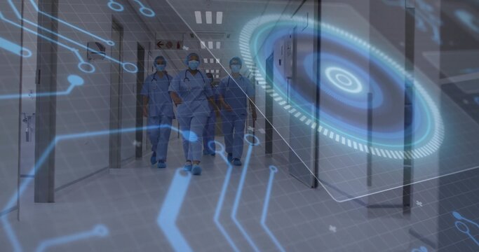 Walking surgical team wearing scrubs caps masks down hospital corridor, with hologram interface