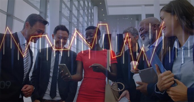 Woman in red dress discussing data analysis in office atrium, with smartphone, tablet, notebook