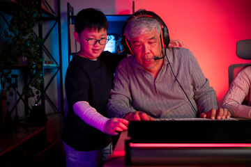 Happy grandparents playing games with grandchildren in in a neon lit room