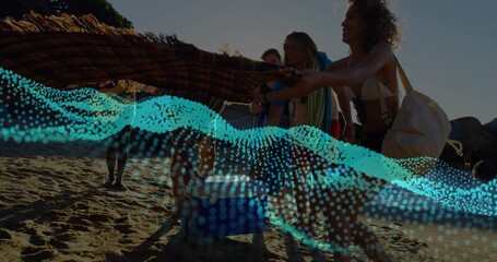 Spreading five friends in swimwear unfolding blanket on sunset shoreline, with blue wave graphic