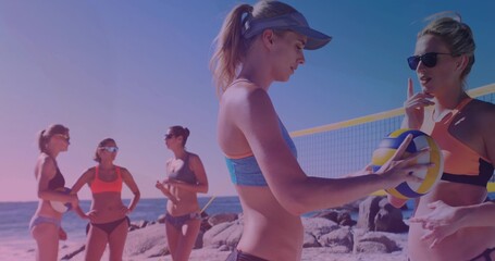 Chatting five women in bikinis preparing beach volleyball on court, with volleyball and net