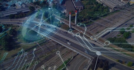 Displaying cable-stayed bridge carrying cars over railway tracks in transit hub with data overlays