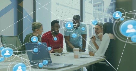 Collaborating professionals reviewing papers and laptops in meeting room, with network overlays