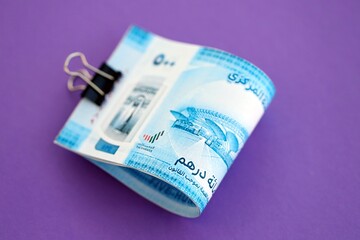United Arab Emirates dirham money bills in big amount on purple. Finance and banking concept