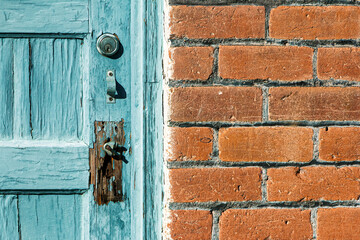 Close-up of a turquoise door on a red brick building in Barrio Viejo. The neighborhood is known for its colorful houses from the 1800s near downtown. Pima County, Tucson, Arizona, USA.
