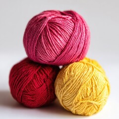 Three yarn balls stacked, vibrant colors