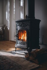 Warmth radiating from a dark gray cast iron wood-burning stove in a cozy room
