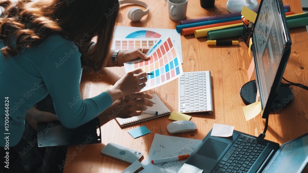 Poster top down view of smart designer helping manager choosing color from colored palettes. aerial view of