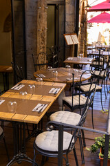Outdoor restaurant tables and chairs waiting for customers in Perugia, Italy