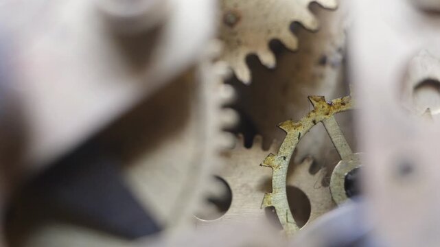 Close up a working geared mechanical clock. The operation of the gear and wheel system in a mechanical watch.