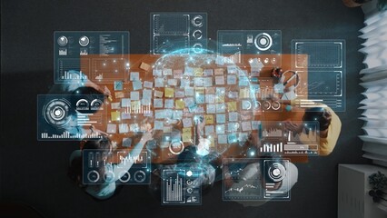 Aerial view of a collaborative team meeting featuring a modern workspace table with digital overlays, data visualization, and diverse professionals engaged in discussion. Raster