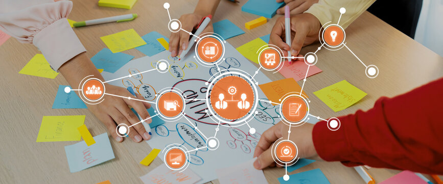 Engaging teamwork scene displaying hands writing on colorful sticky notes, fostering creativity and brainstorming during a collaborative session in a lively workspace. Amity