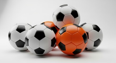 Stack of soccer balls including bright orange one for sports and game fun