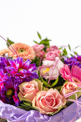 Beautiful bouquet of colorful flowers wrapped in purple paper is showing freshness and beauty