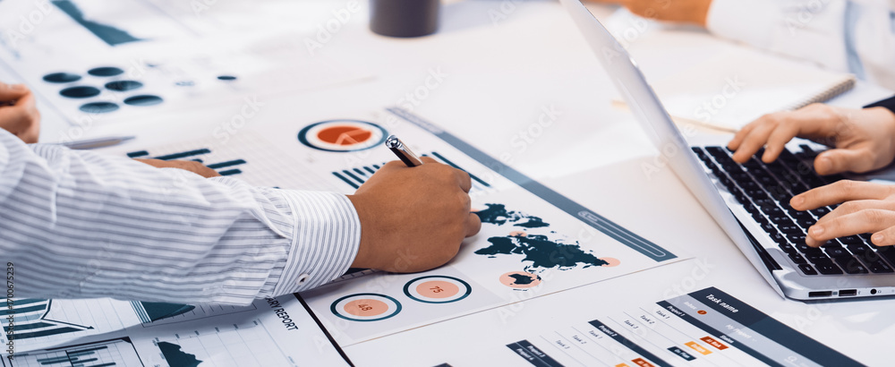 Poster a diverse team engages in a dynamic meeting focused on business analytics. they analyze reports, cha