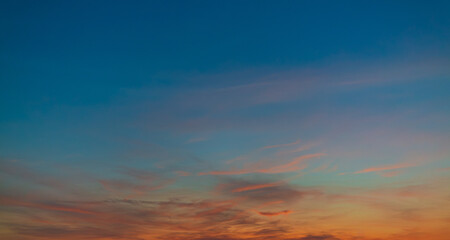 Cloudy background and orange sky in summer morning,Beautiful Vivid sky painted by the sun leaving bright golden shades.
