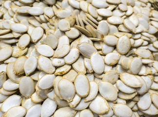 A scattering of raw pumpkin seeds