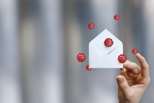 Creative envelope held amidst floating virus illustrations