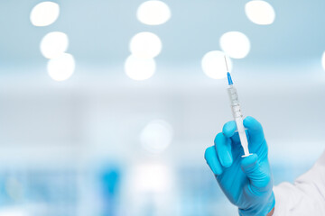 Healthcare professional presents a syringe with precision.