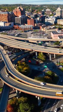 Multilevel highway interchange with bridges and overpasses in Albany, New York. Aerial top view of interstate 787 highway with cars. Vertical video.
