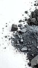 Gray powder and chunks against white