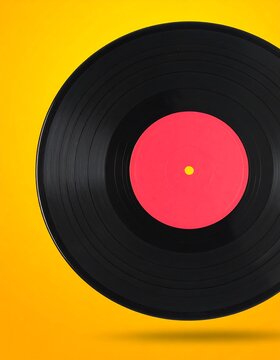 Vinyl record on a vibrant yellow background